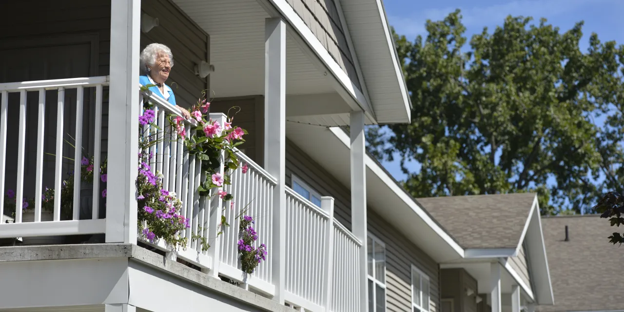 Woman standing on her balcony with flowers