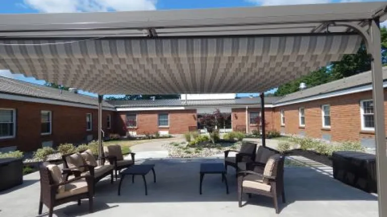 The outdoor courtyard at Kingsway Arms, with patio furniture under an awning