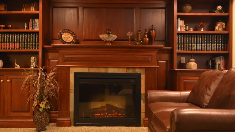 A fireplace with a grand built in mantle in a cozy living space at Kingsway Manor