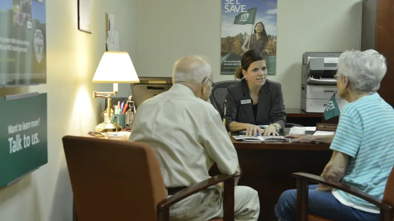 Kingsway administrative worker consults with two clients