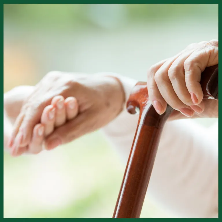 Senior holding a hand and a cane