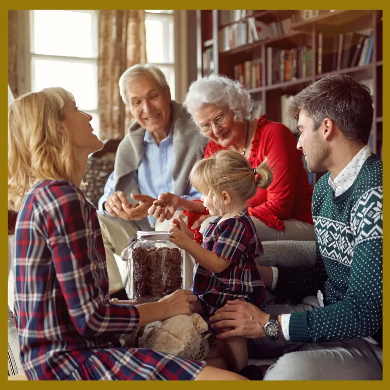 Senior couple with their child, spouse and grandchild at Christmas