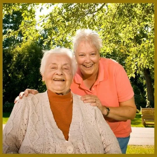 Two older women smiling at camera