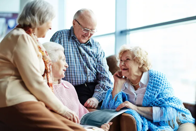 Older adults gathered around socializing