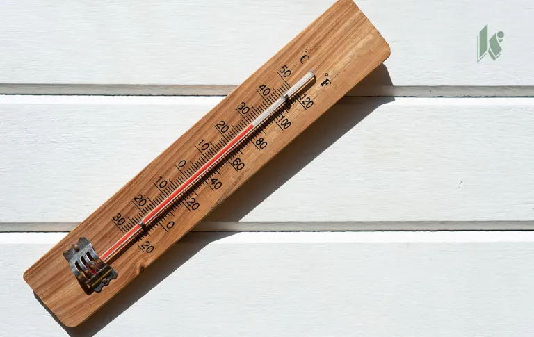A wooden thermometer displays a high temperature in bright sunlight